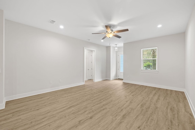 spare room featuring a ceiling fan, recessed lighting, light wood-type flooring, and baseboards