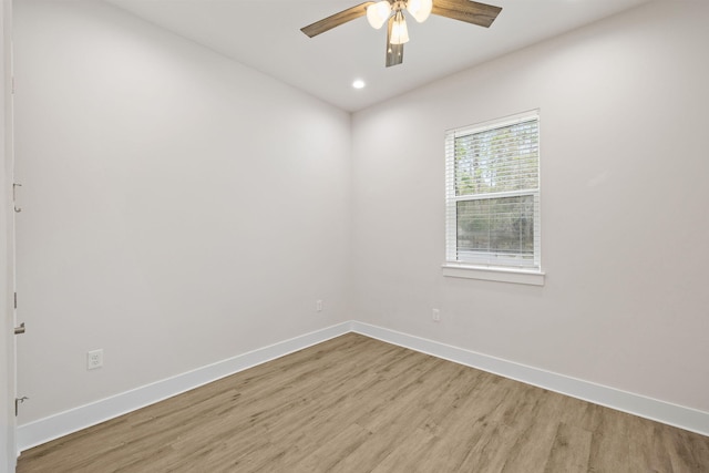 spare room featuring light wood-style flooring, baseboards, ceiling fan, and recessed lighting