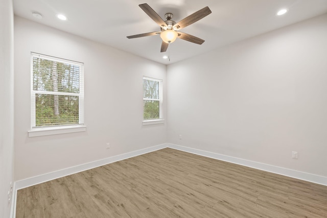 empty room featuring wood finished floors, ceiling fan, baseboards, and recessed lighting