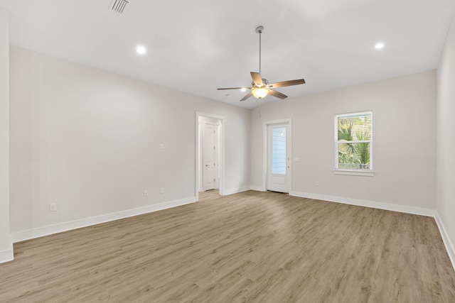 empty room featuring light wood-style floors, baseboards, a ceiling fan, and recessed lighting