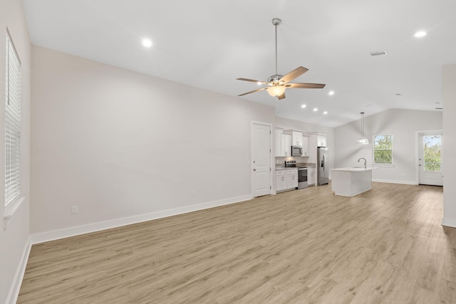 unfurnished living room with vaulted ceiling, ceiling fan, light wood-style flooring, baseboards, and recessed lighting