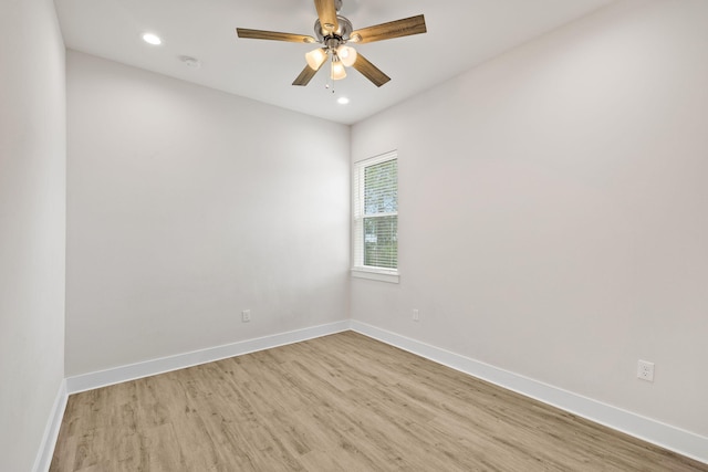 empty room with wood finished floors, baseboards, a ceiling fan, and recessed lighting