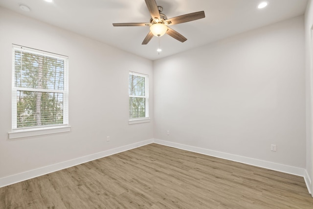 unfurnished room featuring wood finished floors, baseboards, a ceiling fan, and recessed lighting