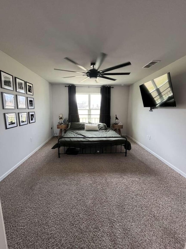 carpeted bedroom with visible vents, a ceiling fan, and baseboards