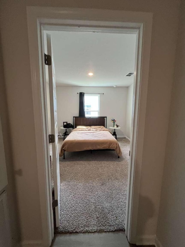 carpeted bedroom with visible vents and baseboards