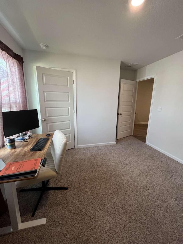 carpeted home office with baseboards