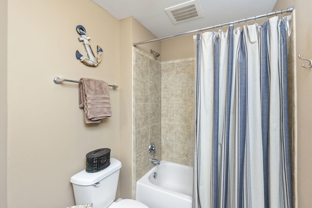 bathroom featuring visible vents, toilet, and shower / tub combo with curtain