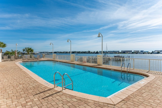 pool featuring a patio area and fence