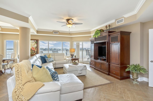 living area featuring visible vents, a wealth of natural light, and ceiling fan