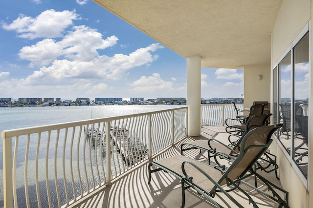 balcony featuring a city view and a water view