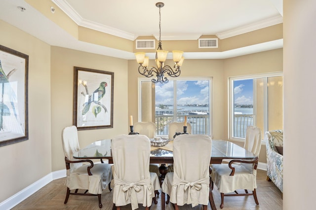 dining area with a notable chandelier, visible vents, baseboards, and ornamental molding