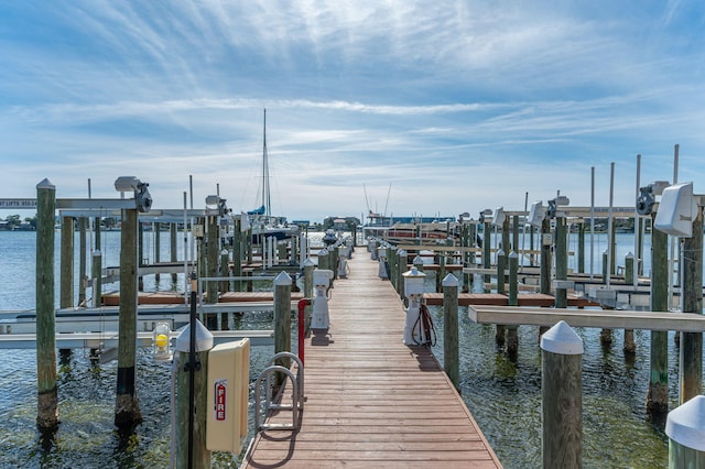 dock area with a water view and boat lift