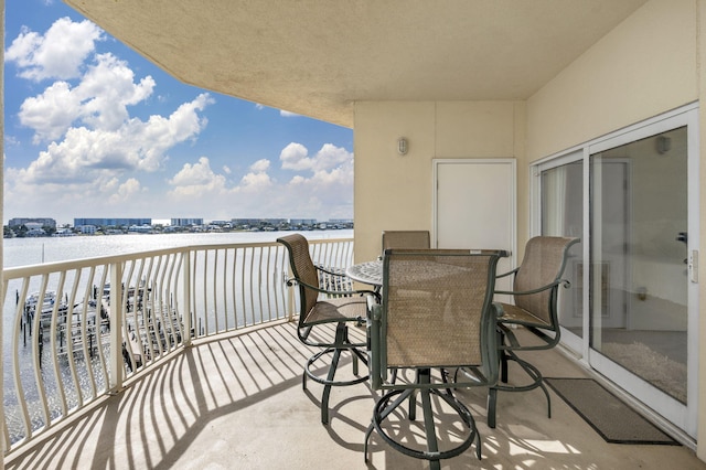 balcony with visible vents and a water view