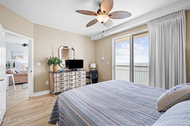 bedroom featuring baseboards, a ceiling fan, light wood-style floors, and access to outside