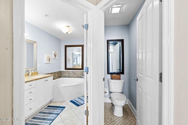 full bathroom featuring vanity, baseboards, toilet, tile patterned floors, and a bath