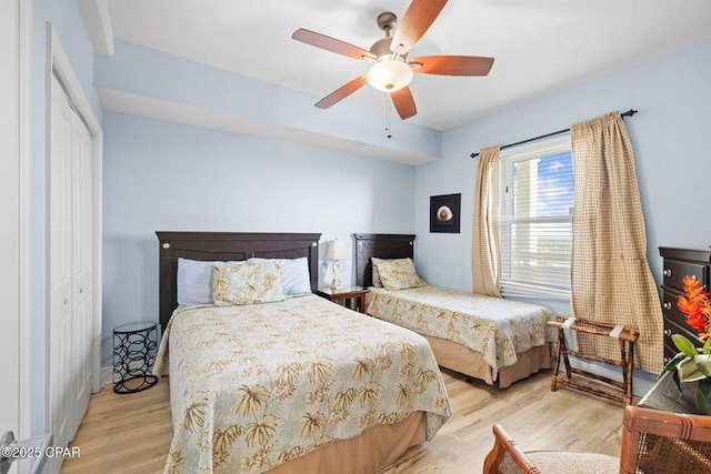 bedroom with ceiling fan, a closet, and wood finished floors