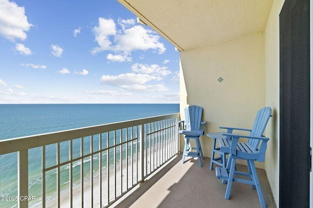 balcony with a view of the beach and a water view