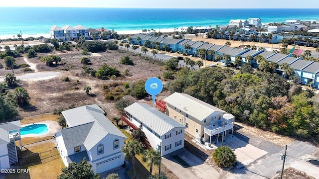 bird's eye view with a residential view, a water view, and a beach view