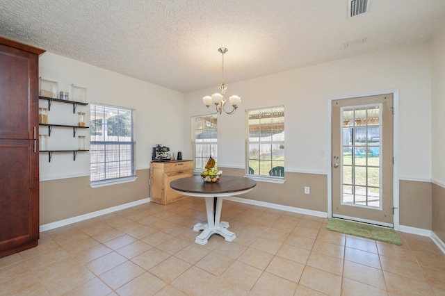 dining space featuring light tile patterned floors, baseboards, visible vents, an inviting chandelier, and a textured ceiling