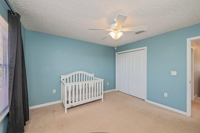 unfurnished bedroom with a closet, visible vents, baseboards, and carpet