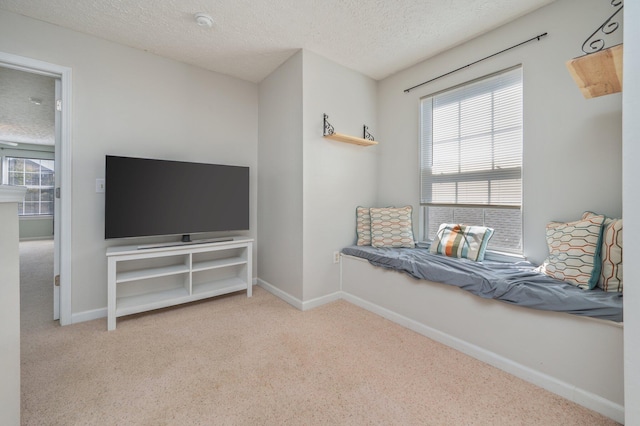 unfurnished room with baseboards, carpet floors, and a textured ceiling