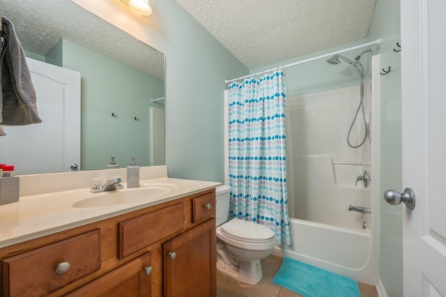 bathroom with tile patterned floors, a textured ceiling, vanity, and toilet