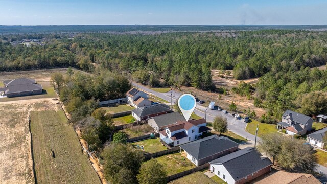 bird's eye view with a residential view and a wooded view