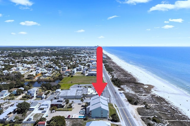 drone / aerial view with a water view and a beach view