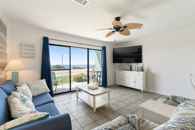 tiled living room featuring visible vents, baseboards, crown molding, and ceiling fan