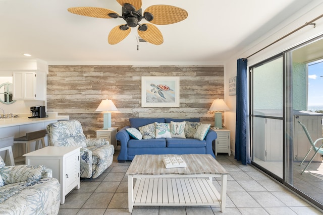 living room with light tile patterned flooring, recessed lighting, wood walls, and ceiling fan