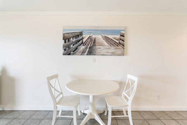 dining space featuring tile patterned floors and baseboards