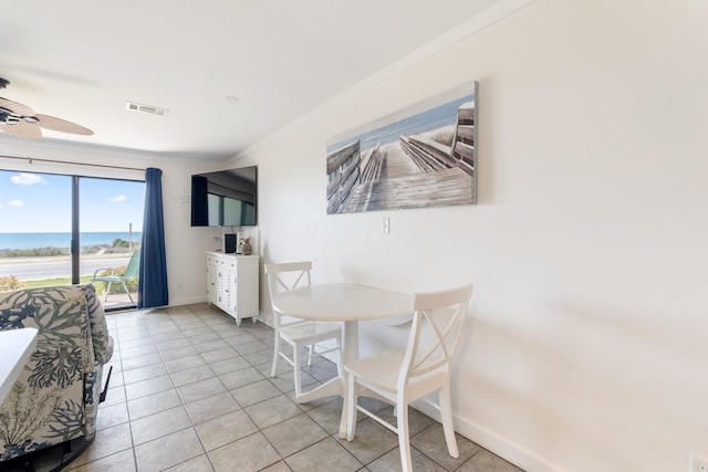 dining space featuring visible vents, baseboards, ornamental molding, light tile patterned floors, and a ceiling fan