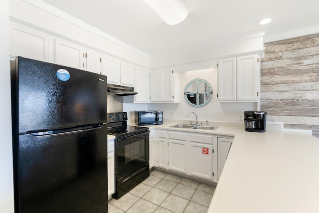 kitchen with a sink, white cabinetry, black appliances, and under cabinet range hood