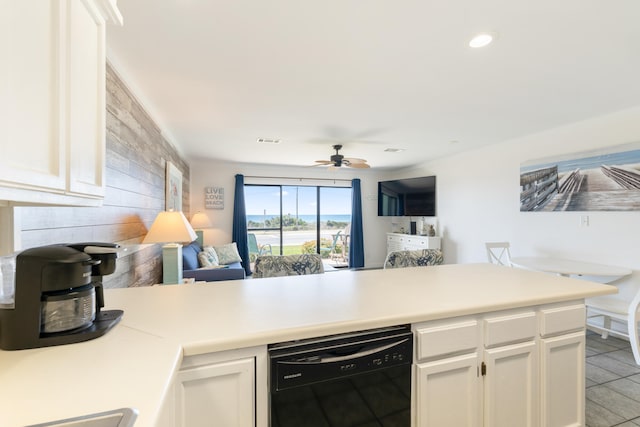 kitchen with ceiling fan, open floor plan, black dishwasher, a peninsula, and white cabinets