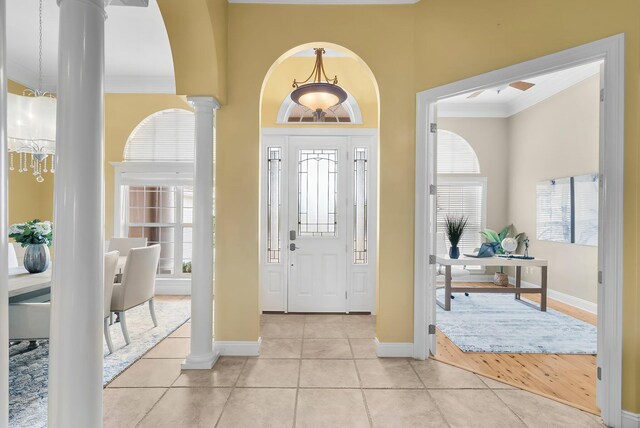 114 Golf Dr, Panama City Beach, FL 32408 - foyer with decorative columns, ornamental molding, light tile patterned flooring, baseboards, and a towering ceiling