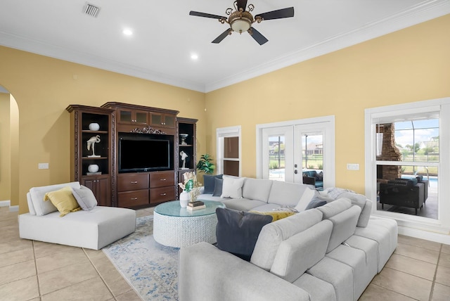 114 Golf Dr, Panama City Beach, FL 32408 - living area featuring arched walkways, light tile patterned floors, a ceiling fan, french doors, and ornamental molding