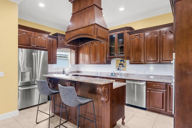 114 Golf Dr, Panama City Beach, FL 32408 - kitchen featuring appliances with stainless steel finishes, a sink, a kitchen island, light stone countertops, and light tile patterned floors