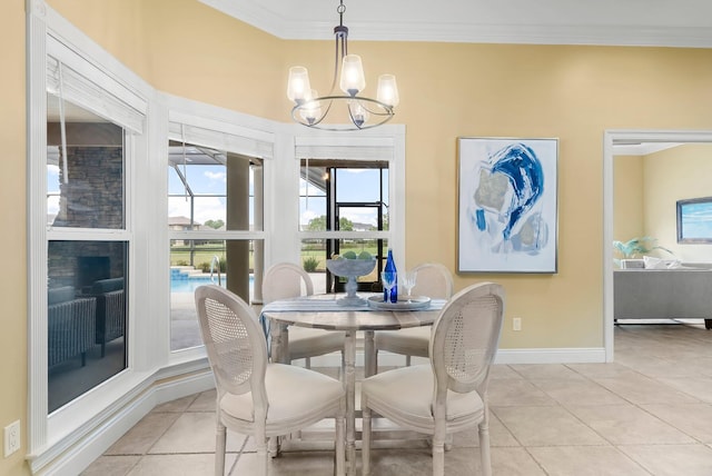114 Golf Dr, Panama City Beach, FL 32408 - dining room with a chandelier, ornamental molding, plenty of natural light, light tile patterned floors, and baseboards