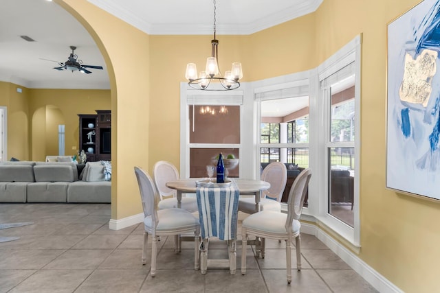 114 Golf Dr, Panama City Beach, FL 32408 - tiled dining room with arched walkways, crown molding, ceiling fan, a chandelier, and baseboards