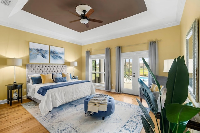 114 Golf Dr, Panama City Beach, FL 32408 - bedroom with a raised ceiling, access to outside, french doors, and light wood-style flooring