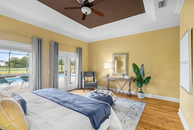 114 Golf Dr, Panama City Beach, FL 32408 - bedroom with access to outside, a tray ceiling, french doors, wood finished floors, and baseboards