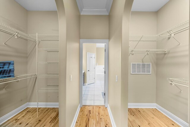 114 Golf Dr, Panama City Beach, FL 32408 - walk in closet featuring arched walkways and wood finished floors