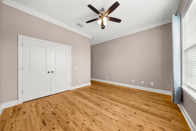 114 Golf Dr, Panama City Beach, FL 32408 - unfurnished bedroom featuring crown molding, light wood finished floors, baseboards, a ceiling fan, and a closet