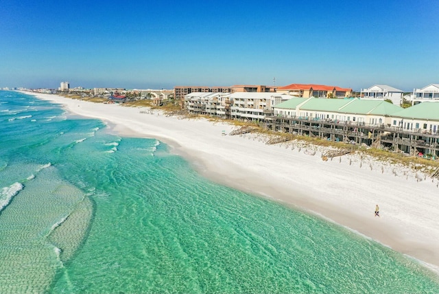 drone / aerial view with a water view and a beach view