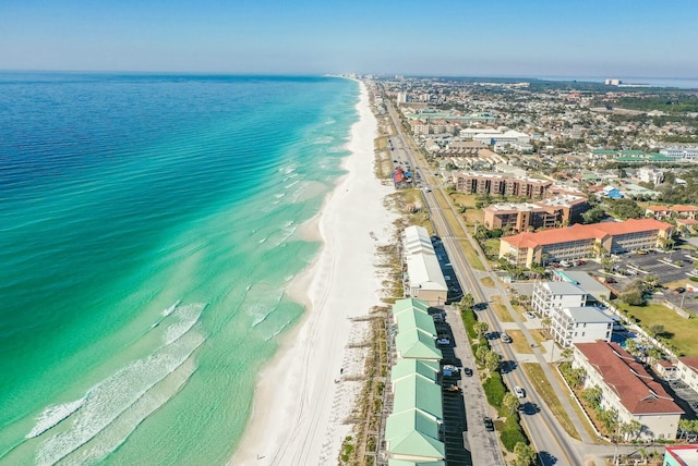 birds eye view of property featuring a water view and a beach view