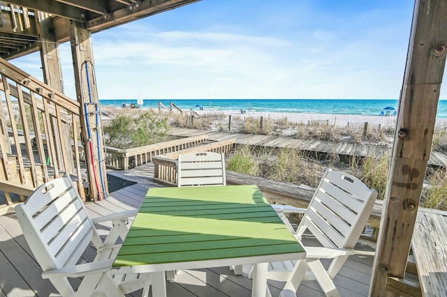 balcony with a deck with water view and a beach view