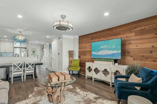 living area with recessed lighting, dark wood-style floors, and wood walls