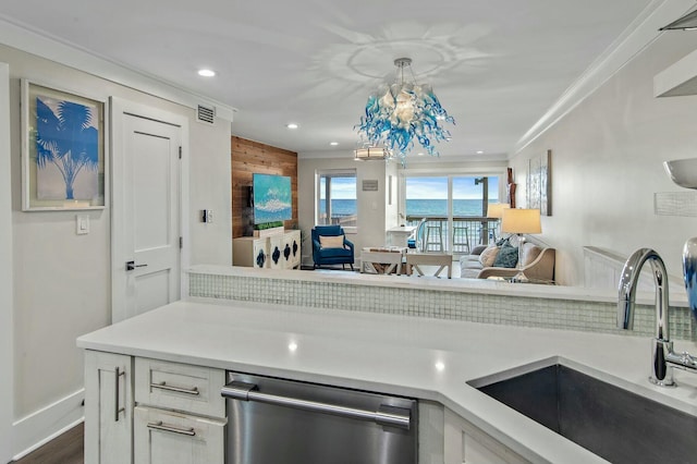 kitchen with visible vents, a sink, open floor plan, light countertops, and dishwasher