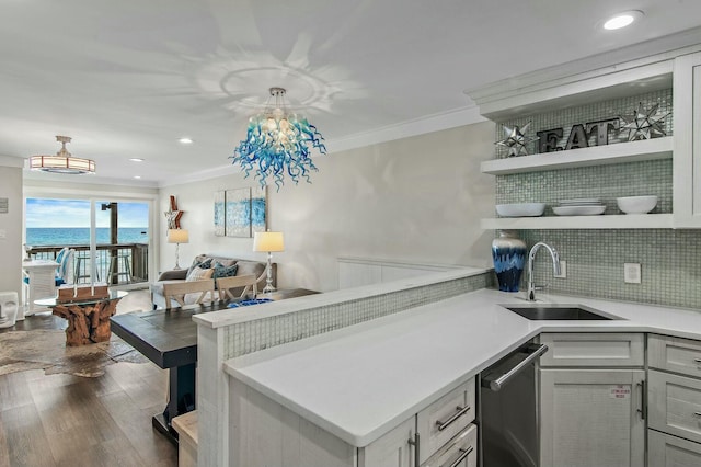 kitchen with open shelves, ornamental molding, backsplash, and a sink