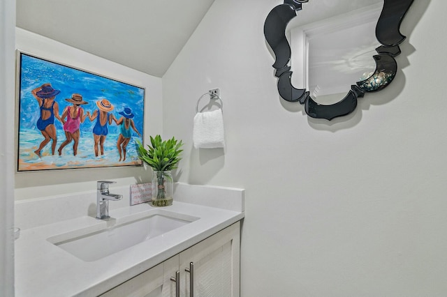 bathroom featuring vanity and vaulted ceiling